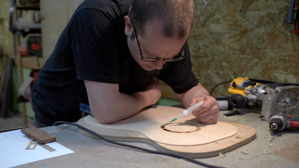 istock The guitar master pastes the rosette into a classical guitar. 979199062