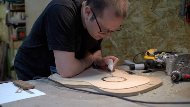 istock The guitar master pastes the rosette into a classical guitar. 979199696