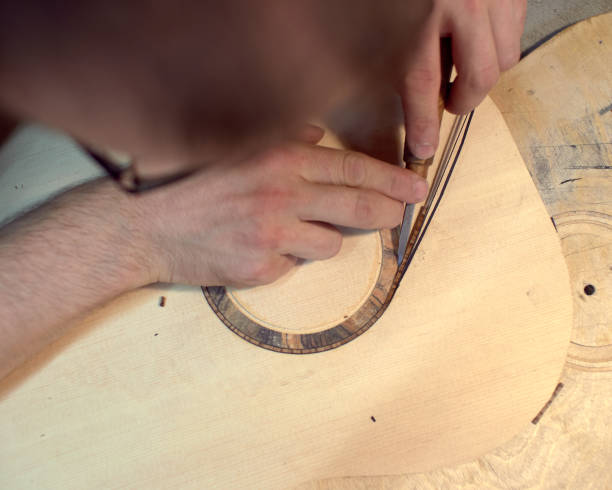 istock The guitar master installs  rosette in a classical guitar. 979199700