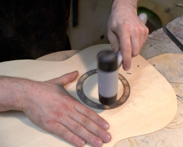 istock The guitar master installs  rosette in a classical guitar. 979199722