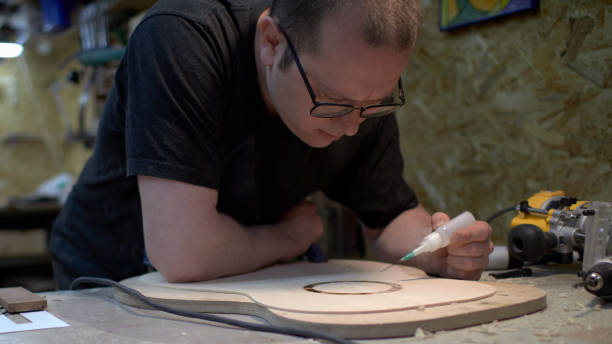 istock The guitar master pastes the rosette into a classical guitar. 979199814