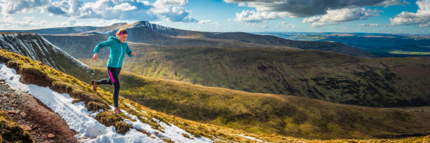 istock Young woman trail runner running along mountain ridge wilderness panorama 979206284