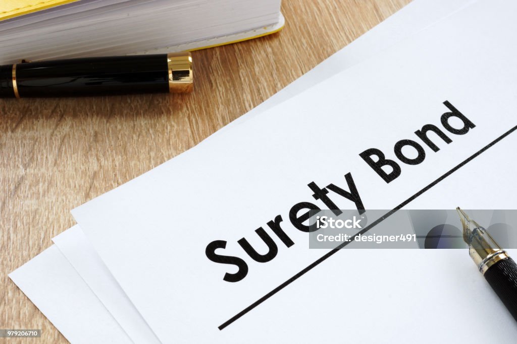 Surety bond form and pen on a table. Bond - Financial Item Stock Photo