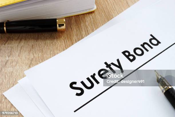 Surety Bond Form And Pen On A Table Stock Photo - Download Image Now - Bond - Financial Item, Insurance, Bail - Law