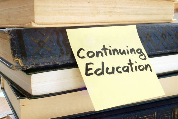 istock Memo stick with words Continuing education and books. 979207256