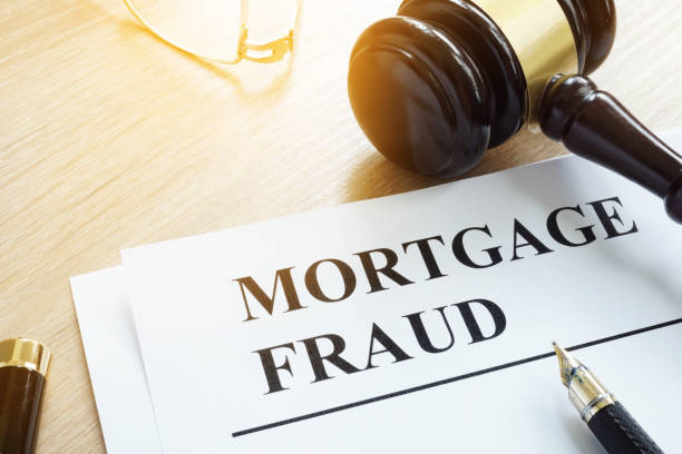 istock Mortgage fraud evidences and gavel on a desk. 979210510