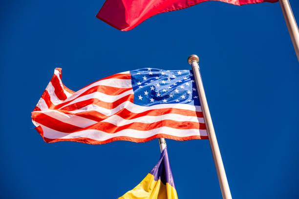 istock American Flag against blue sky 979211512