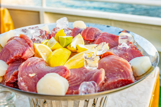istock Fresh uncooked tuna steaks with lemon and lime on a plate 979212936