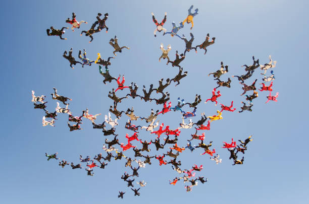 A group of parachutists jumping from parachute on March 27, 2012 in Eloy Arizona, USA A group of parachutists making formation from parachute on March 27, 2012 in Eloy Arizona, USA skydiving stock pictures, royalty-free photos & images