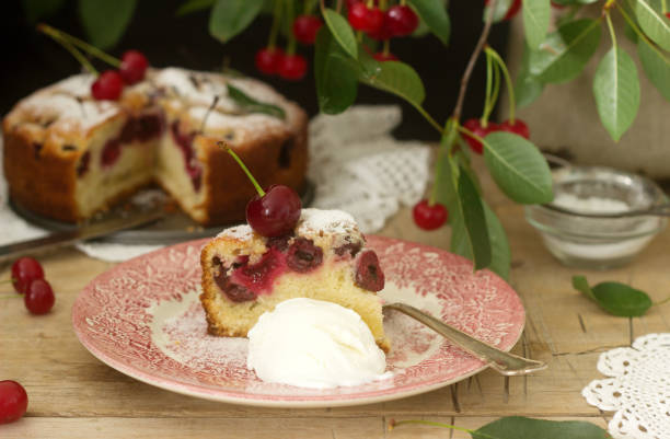 istock A piece of cherry pie and ice cream on the background of cherry tree branches. Rustic style. 979216700