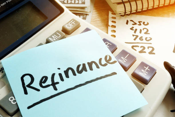 istock Refinance written on a memo stick and calculator. 979217572