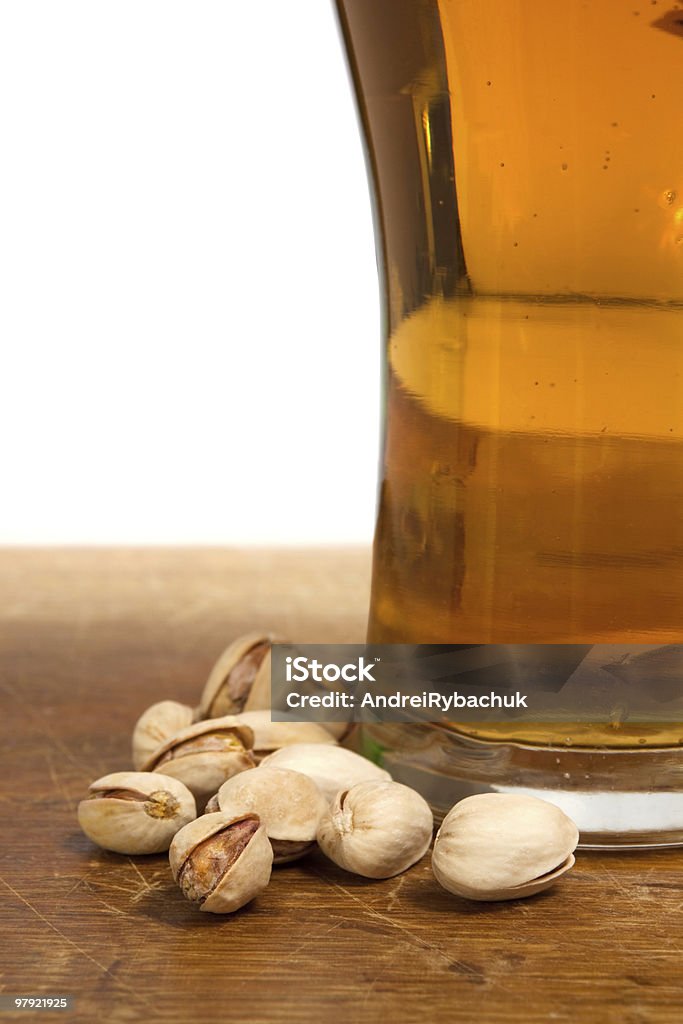 유리컵 맥주 및 pistachios 있는 나무 탁자 - 로열티 프리 0명 스톡 사진