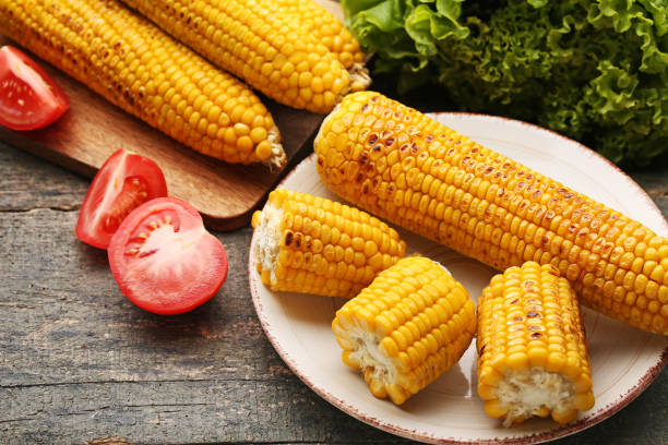istock Tasty grilled corns with tomatoes on grey wooden table 979230042