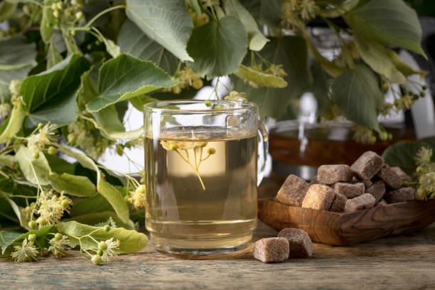 istock Glass of linden tea with brown sugar . 979230234