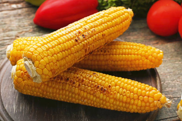 istock Tasty grilled corns on grey wooden table 979231292