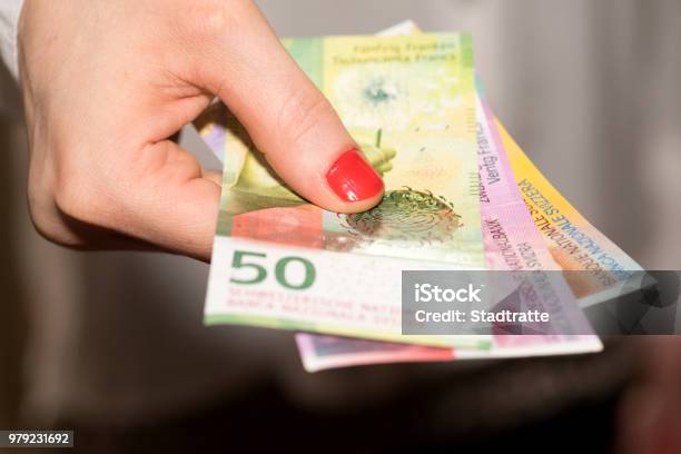 A Woman Holds Swiss Franc Banknotes In Her Hand Stock Photo - Download Image Now - Swiss Currency, Switzerland, Currency