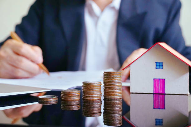 istock Stack of money on working table with background business man. 979237122
