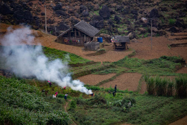 Ha Giang, Vietnam - March 18, 2018: Local population burning grass in a village in northern vietnams. Burnings in southeast Asia are becoming a major health and environmental issue
