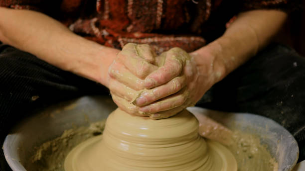 istock Professional male potter working with clay on potter's wheel 979238566
