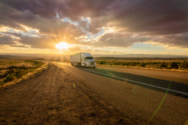 istock Semi Truck Heading East Bound With a Beautiful Sunset 979246174