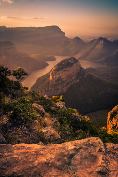 Portrait Shot of Blyde River Canyon bathed in dreamy warm pinks and oranges during pre-sunset golden hour. Mpumalanga, South Africa Blyde River Canyon is a popular tourist destination in South Africa, featuring staggering natural landscapes and rock formations blyde river canyon stock pictures, royalty-free photos & images