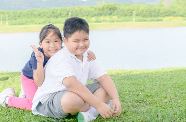 istock Brother and sister smile and look at camera 979247968