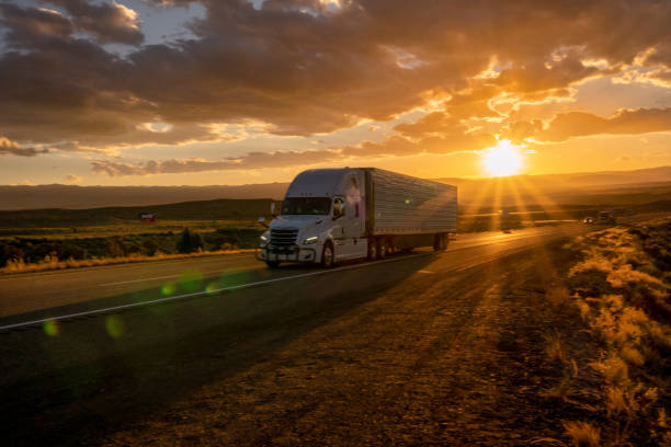 istock Semi Truck Heading East Bound With a Beautiful Sunset 979252176