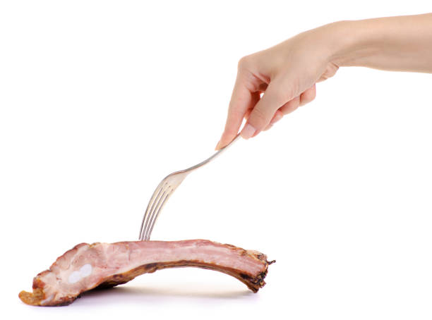 istock Pork smoked ribs fork in hand 979257858