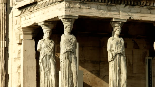 zoom in shot of the erechthion maidens in athens, greece