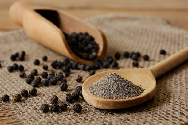 Ground black pepper Ground Black Pepper and Peppercorns with wooden spoon and scoop.

Studio shot on June, 18, 2018 black peppercorn stock pictures, royalty-free photos & images