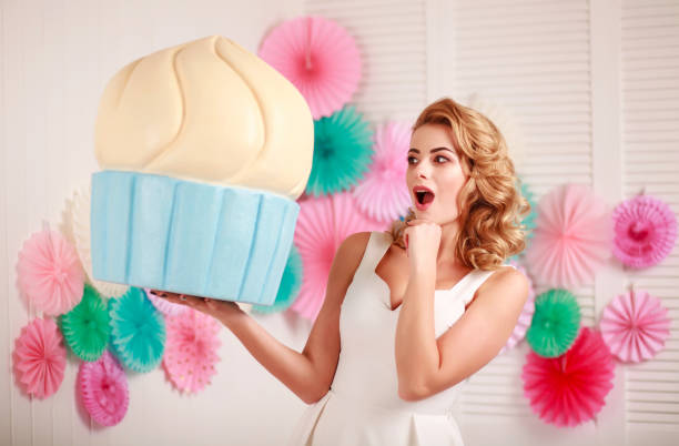 istock Woman with huge marshmallows and lollipop sweets dream 979264922