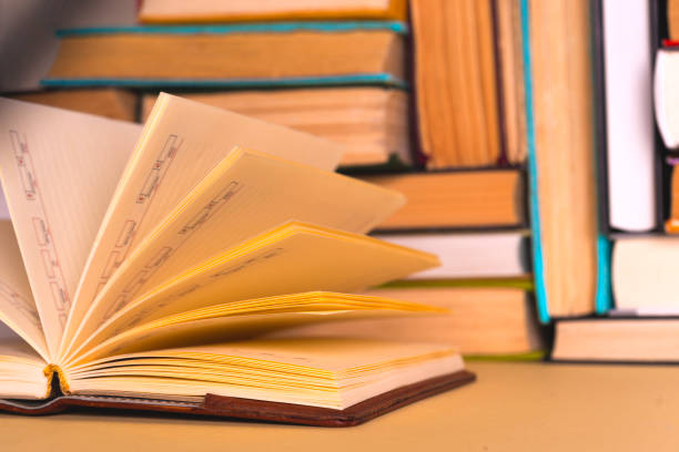 istock Open book, hardback books on bright colorful background. 979269170