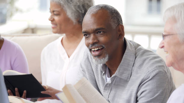 istock Man discusses something during book club gathering 979269396