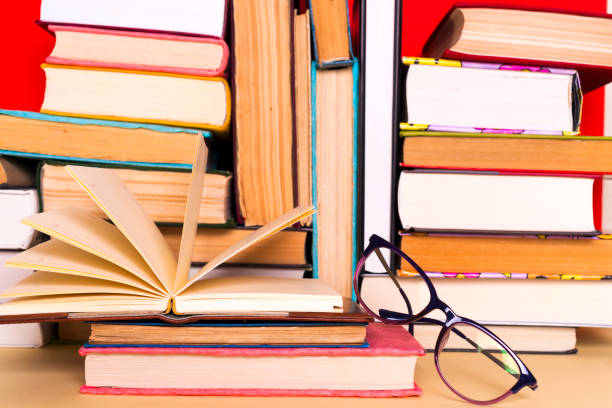 istock Open book, hardback books on bright colorful background. 979269490