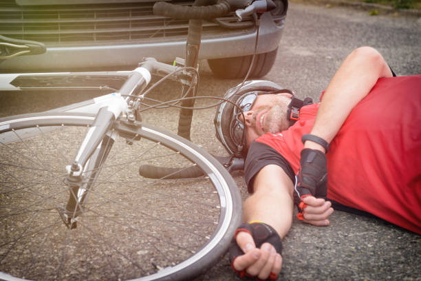 istock Cyclist lying on the road after hitting by a car 979269588