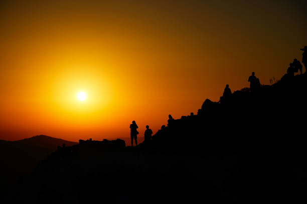 istock People observing sunset at hill on Folegandros island, Greece 979270090