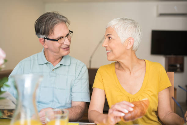 istock Senior couple looking at each other over a breakfast 979273302