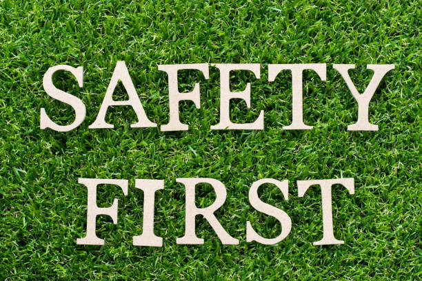 istock Wood alphabet in word safety first on artificial green grass background 979281506
