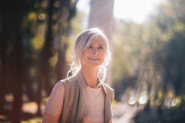 istock Smiling senior woman relaxing in nature in spring 979296110