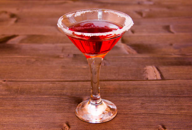 istock Red cocktail with decorated with sugar on a wooden table 979297014