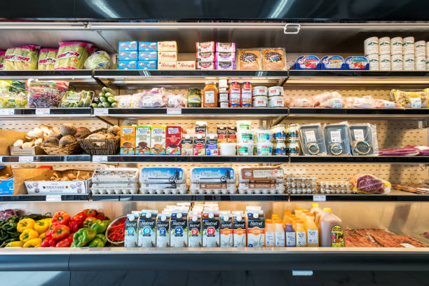Refrigerator shelves in a grocery delicatessen store Refrigerator shelves with vegetables, dairy products, meat, eggs, caviar in a grocery delicatessen store. refrigerated section supermarket photos stock pictures, royalty-free photos & images