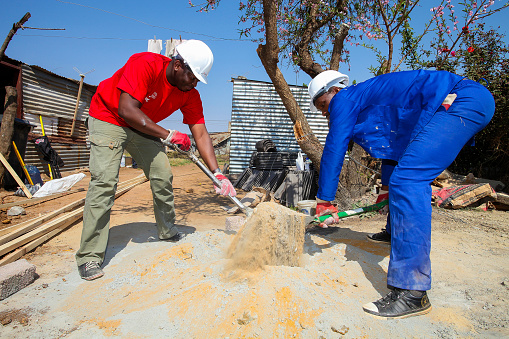 Johannesburg, South Africa, September 10, 2011,  Diverse Community members join PWC's Corporate Social Investment initiative in building a low cost house as a team in Soweto Johannesburg