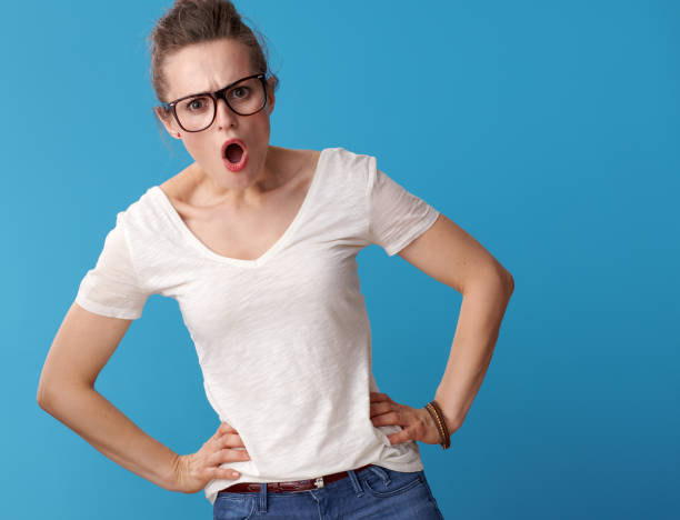 istock surprised modern hipster in white shirt on blue 979305224