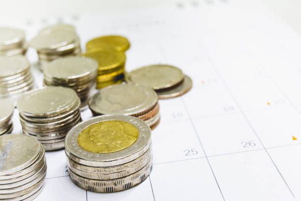 istock Thai baht coins on the calendar. 979314736