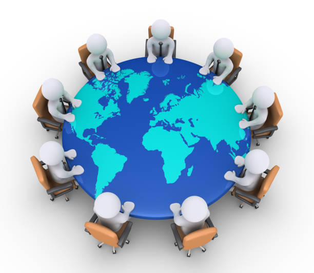istock Businessmen sitting on chairs and table with world map 979314840
