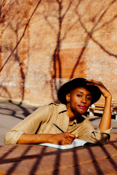 istock Female writing outside and looking at camera 979315176