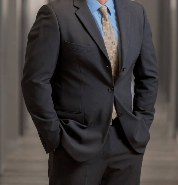 istock Cropped Head Man standing in a smart suit 979315602