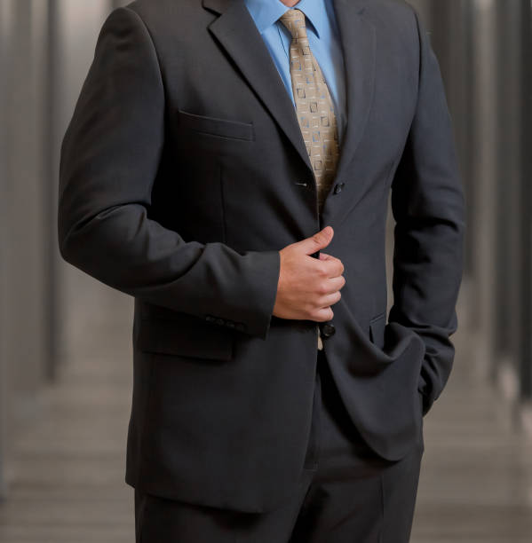 istock Cropped Head Man standing in a smart suit 979315662