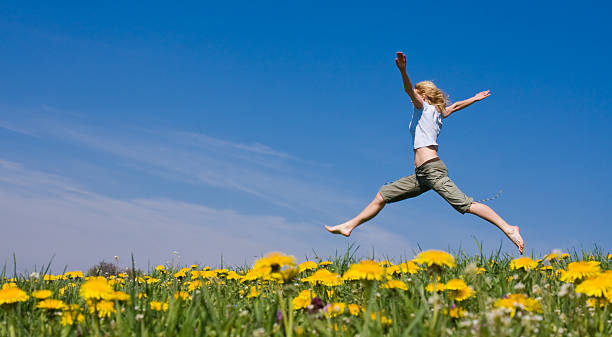 young female having fun on flowery meadow