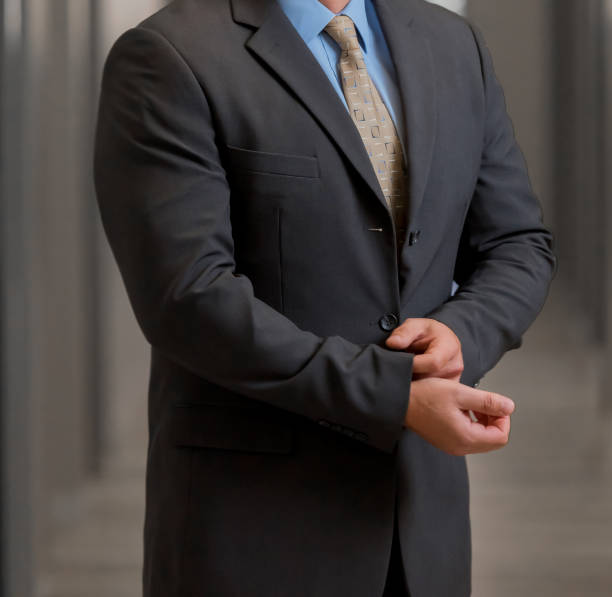 istock Cropped Head Man standing in a smart suit 979315926